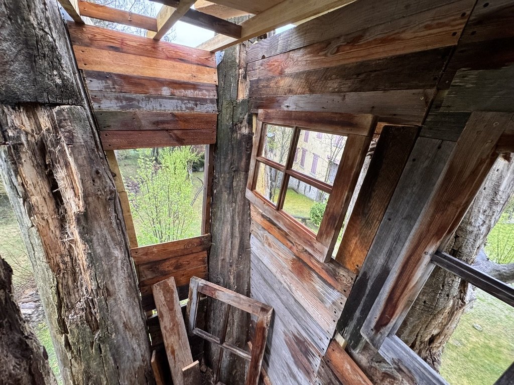Interior corner with reclaimed timber walls and a wooden window opening