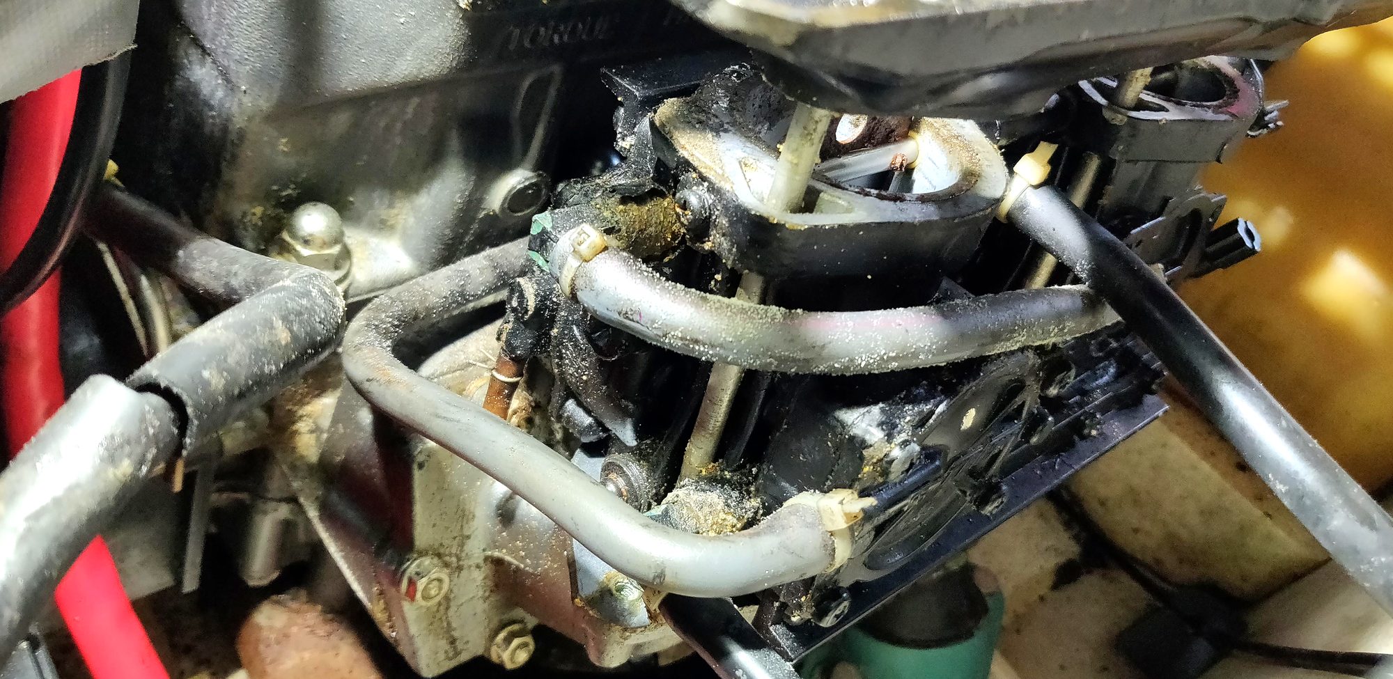Close-up of the open jet ski engine bay with hoses and intake