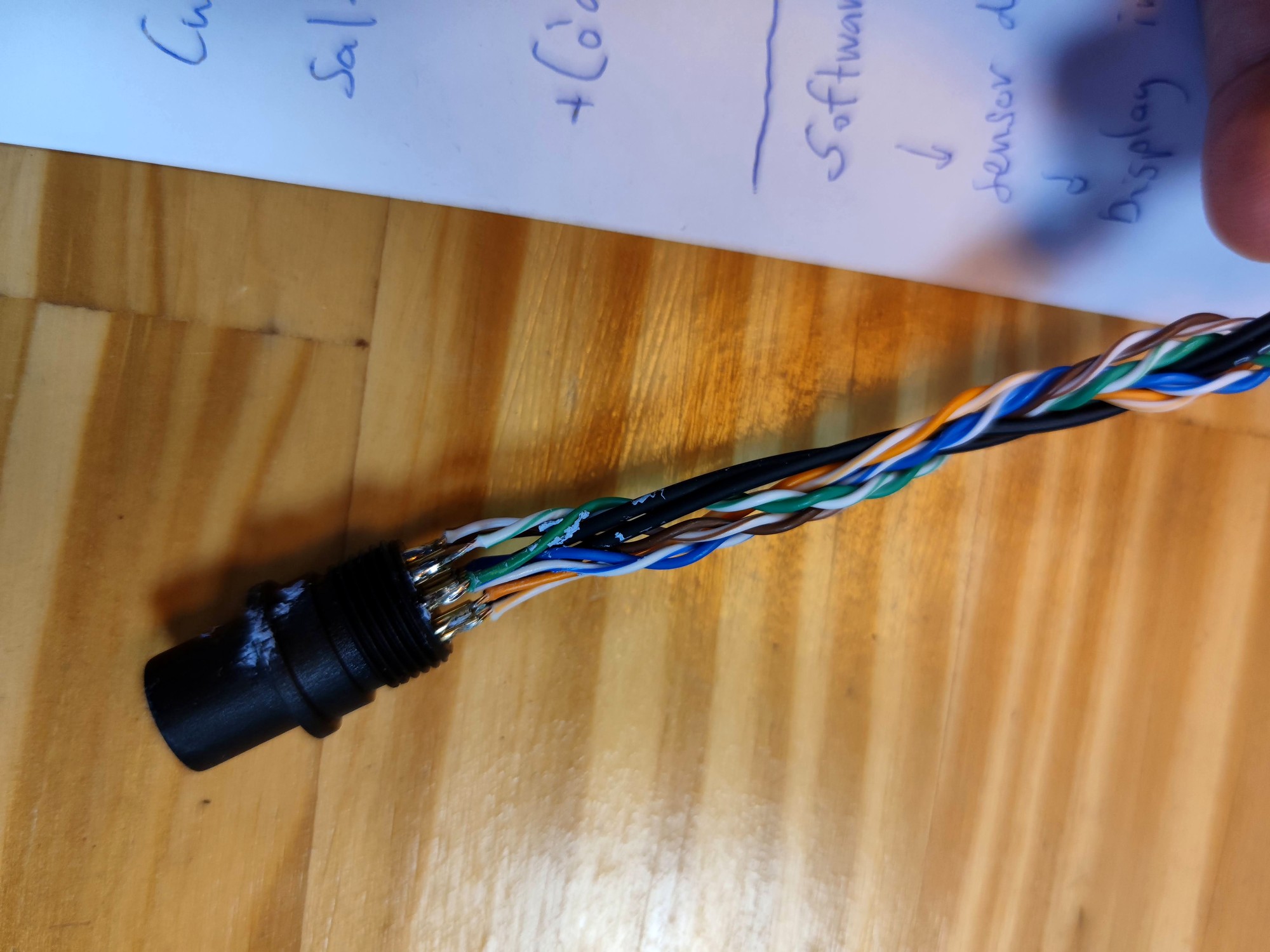 Color-coded wires soldered into the back of a black threaded connector